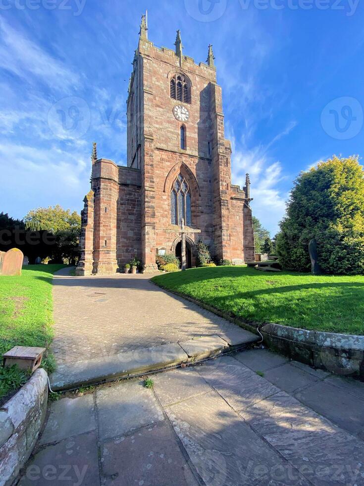 A large brick church with a clock tower photo