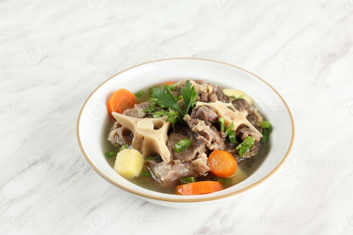 Close Up Sop Buntut, Indonesian Oxtail Soup with Potato and Carrot photo