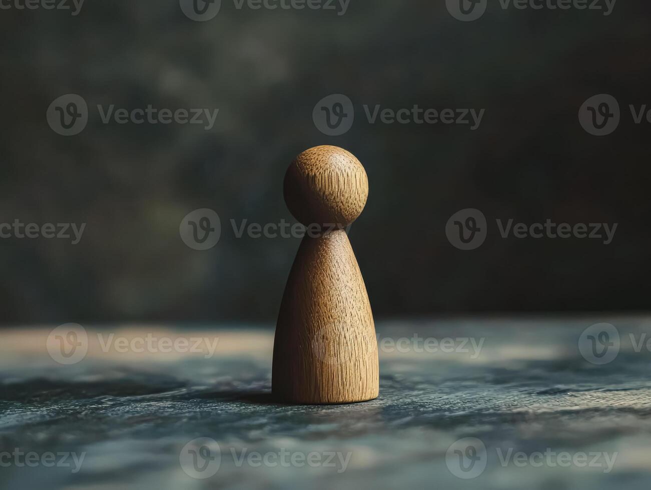 Wooden figure of a person is standing on a table photo