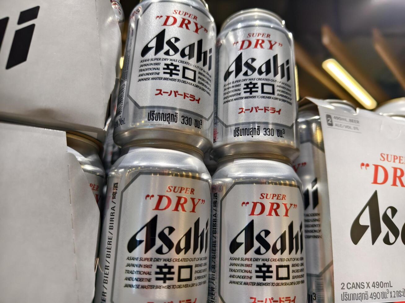 PHUKET, THAILAND - MARCH 8, 2025. Bottles of Asahi beer lined up neatly on a shelf photo
