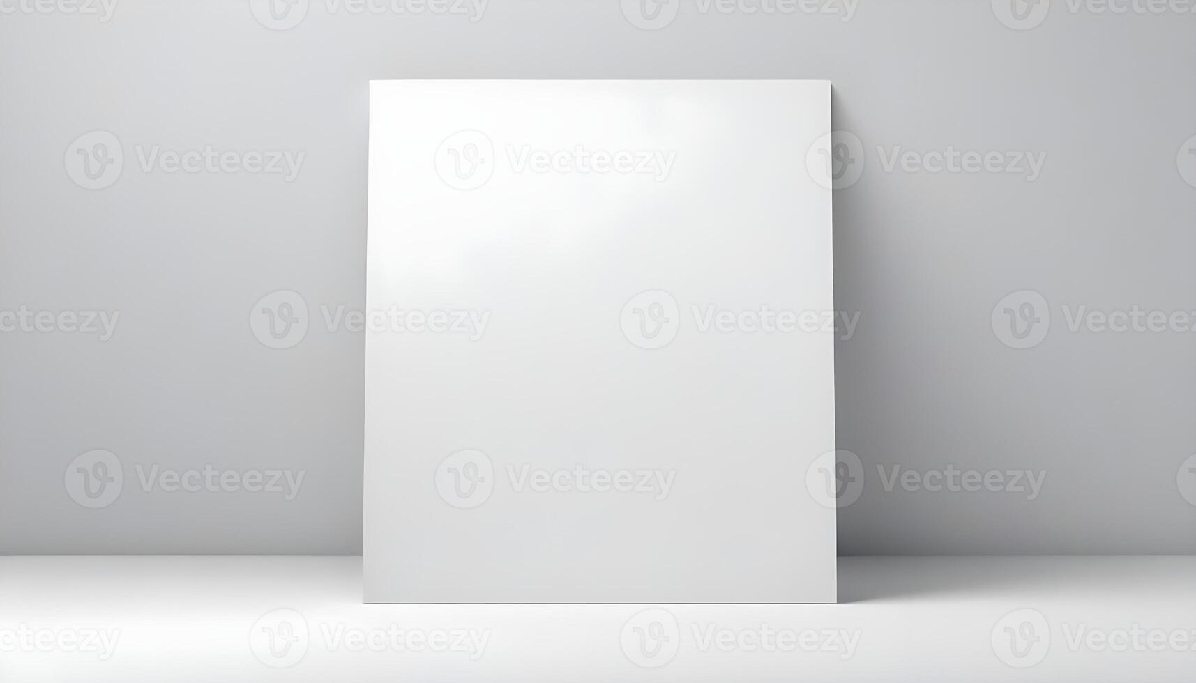 A large, blank white canvas leans against a gray wall, perfect for any design idea or art. photo