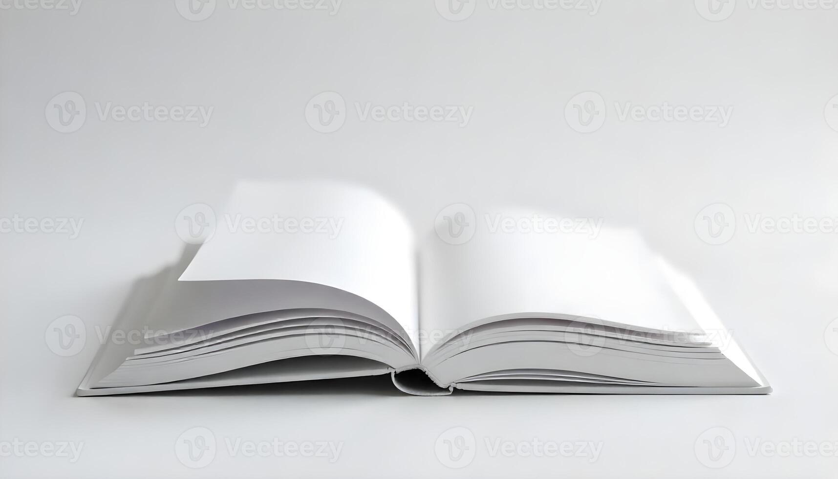 A studio shot shows an open book with blank pages, set against a clean white background. photo