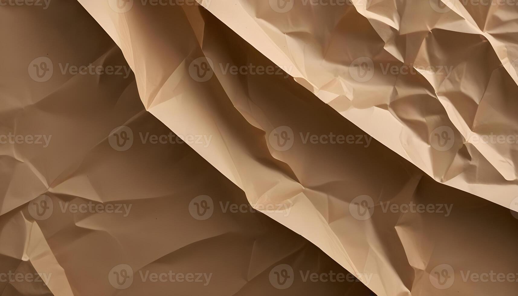 Close-up of folded beige paper creates an abstract pattern of shadows and textures. photo