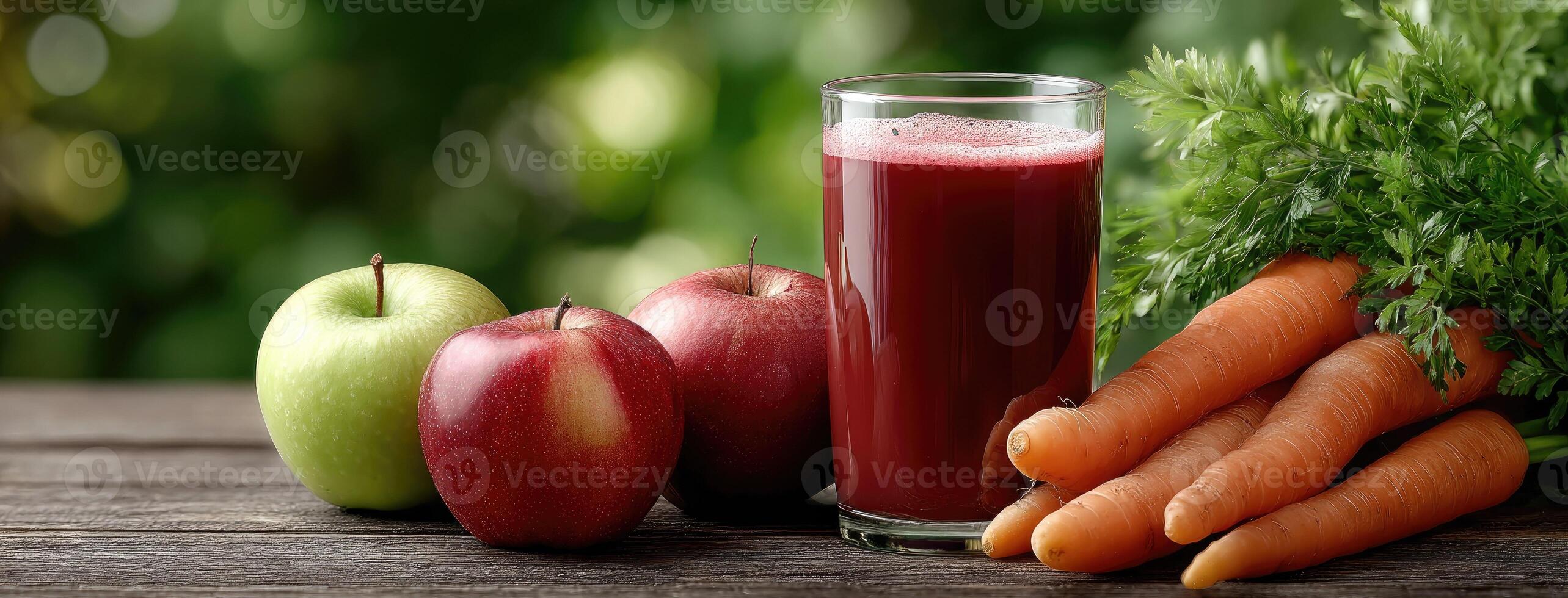 Carrots, apples and juice on a table photo