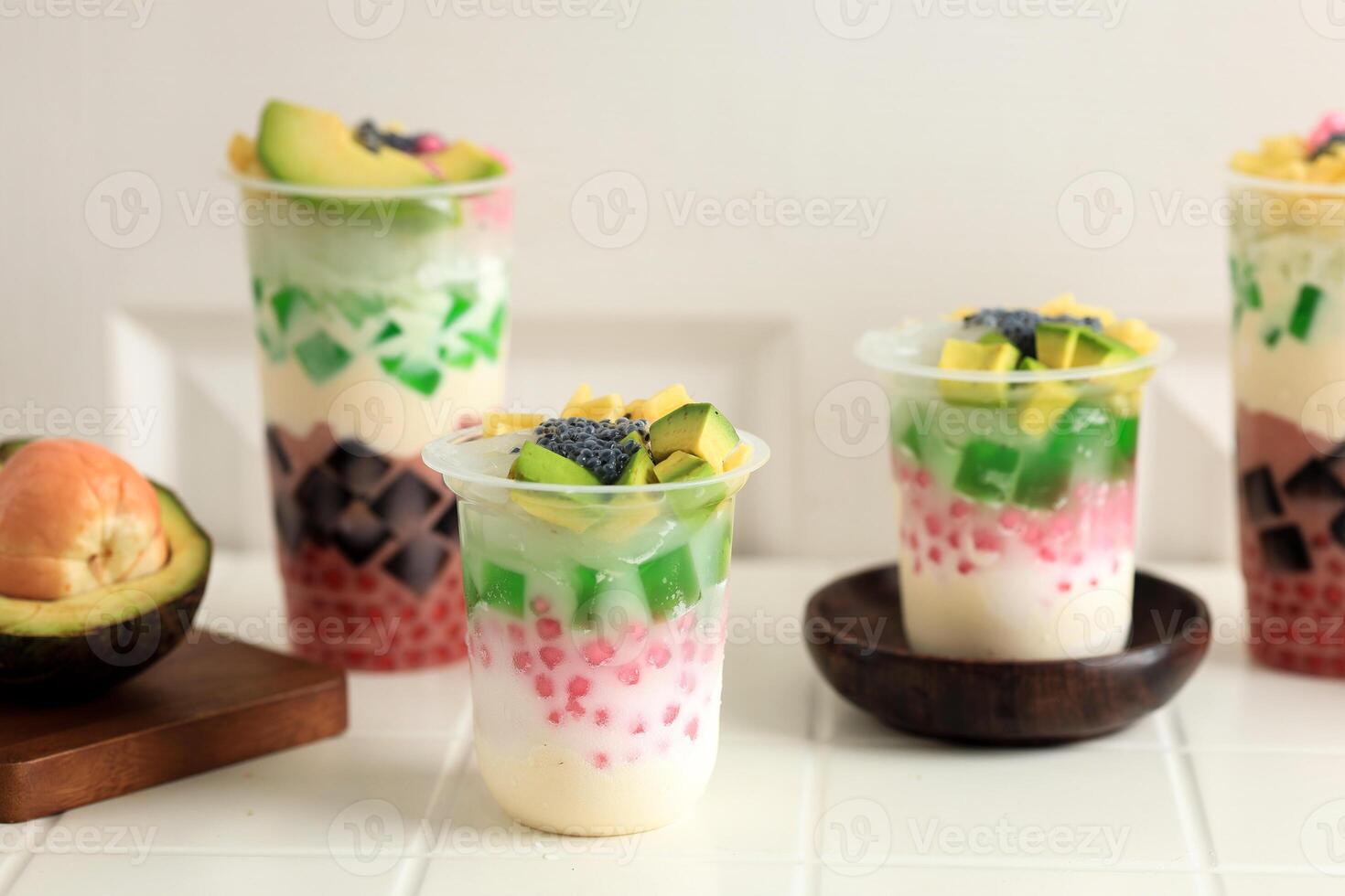 Various Size Cup of Es Teller Sultan in Plastic Cup, Indonesian Traditional Mix Fruit Popular Street Food photo