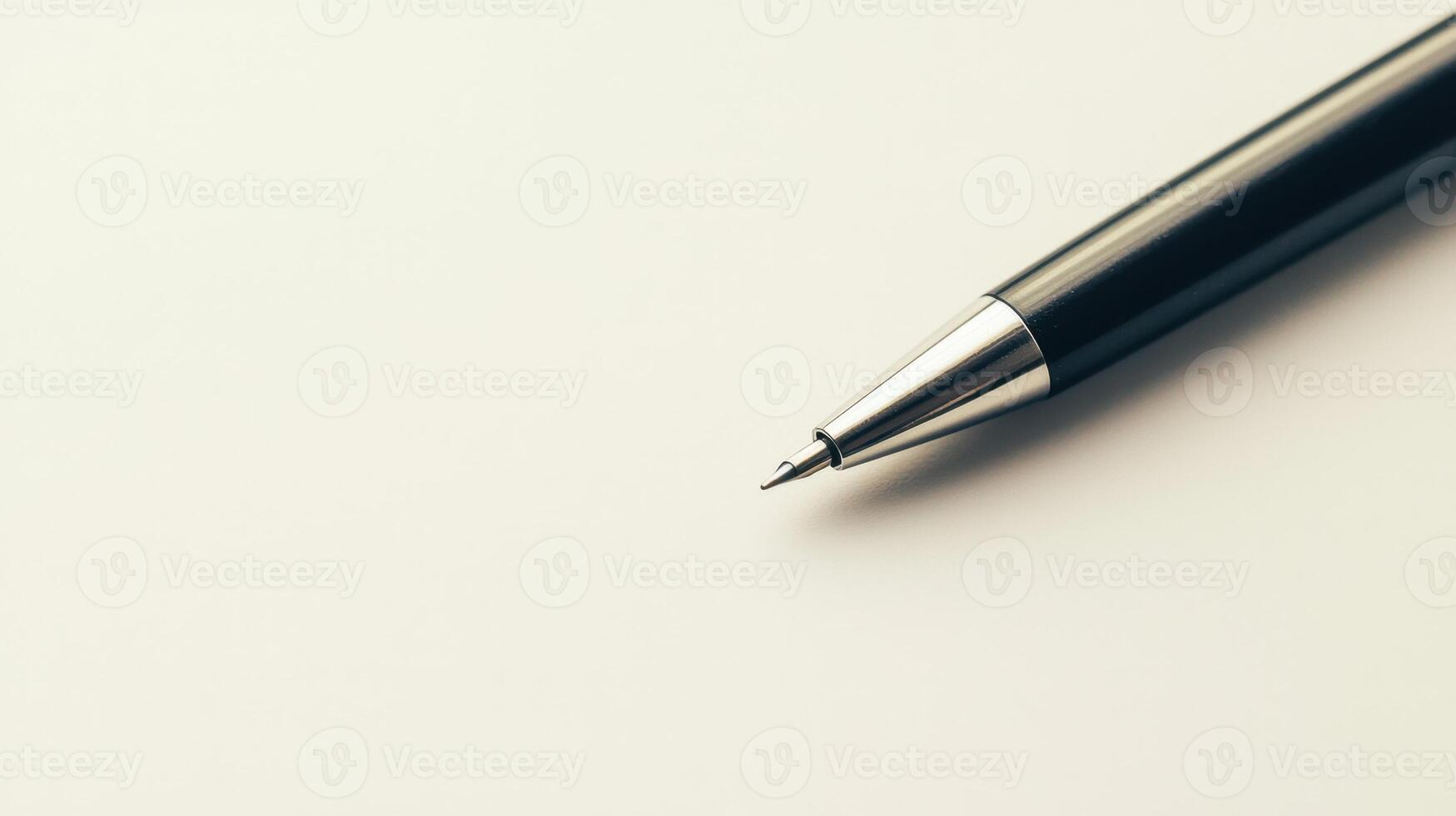A pen on a white surface with copy space photo