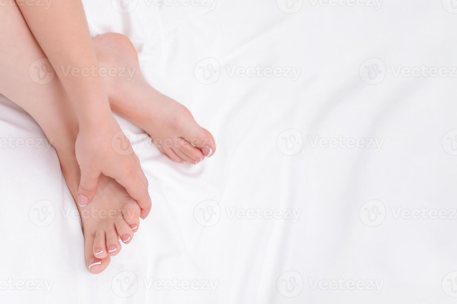 women's legs and hands with beautiful manicure and pedicure photo