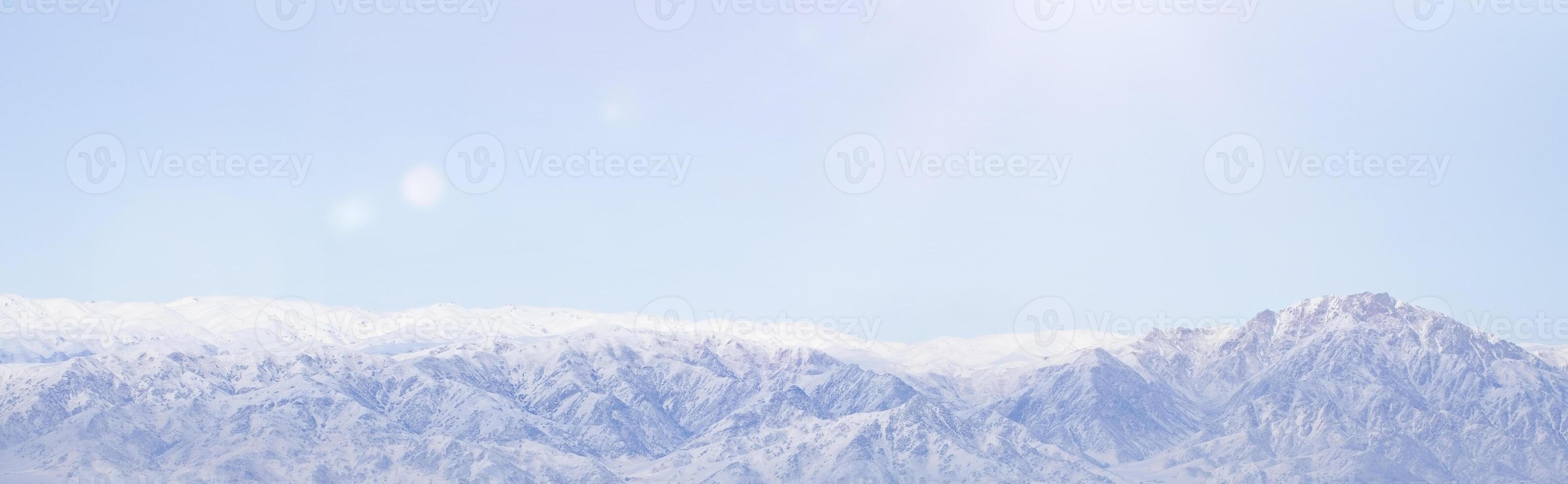 panoramic view of snowy mountains and clouds. photo