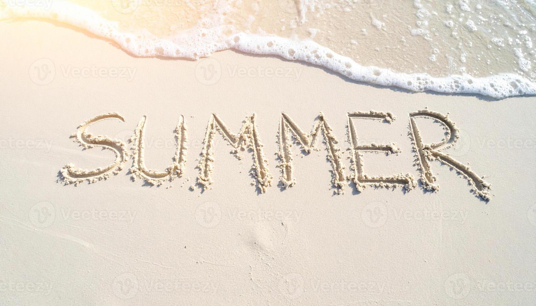 daylight summer background with finger written text on sand and sunny beach vibe photo
