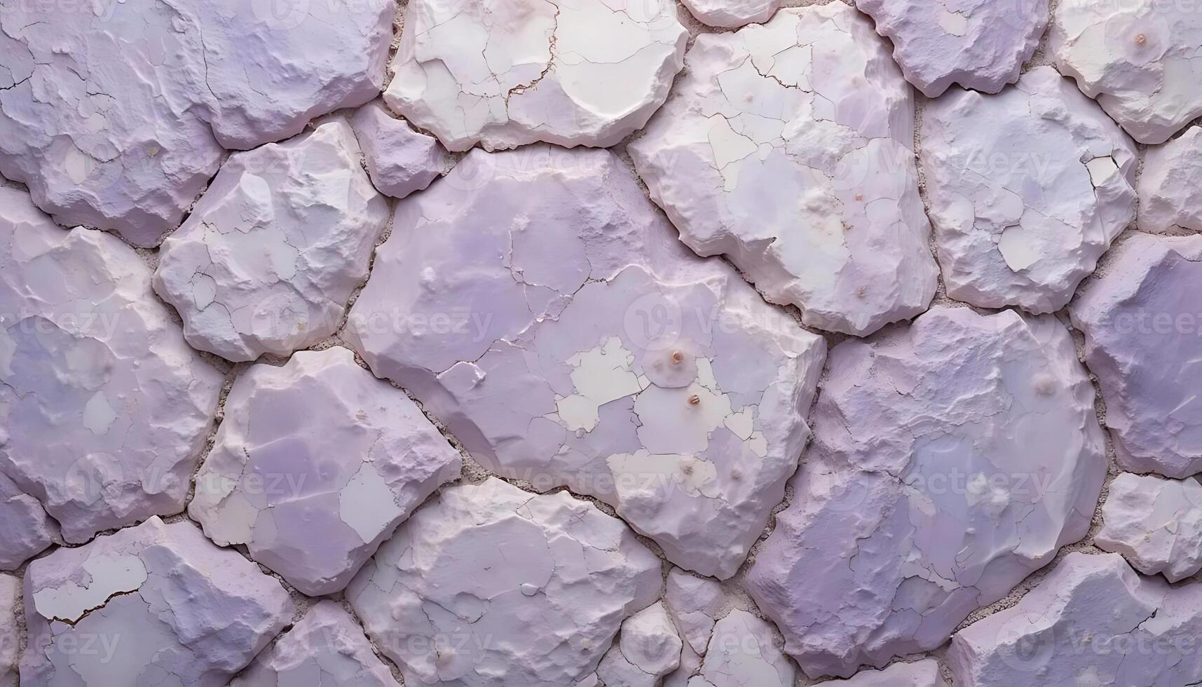 Close up view of textured stone wall with purple and white paint creating a unique abstract design photo