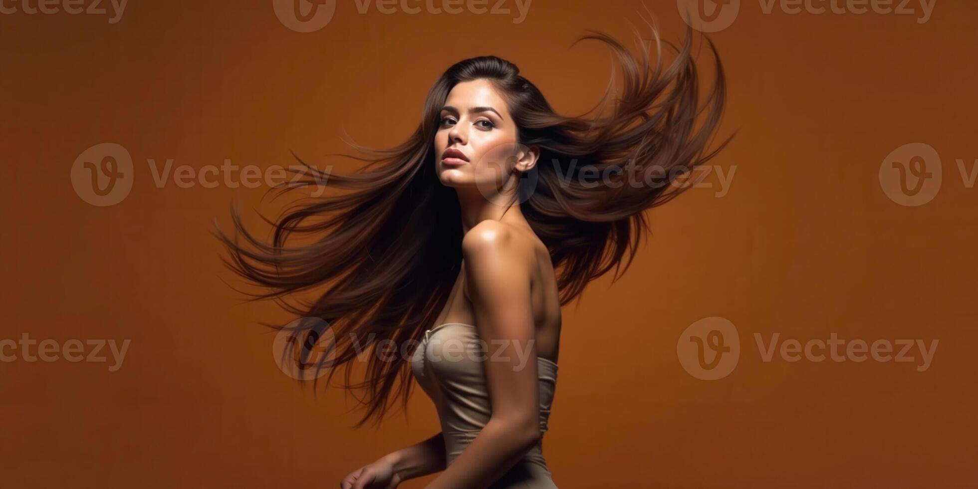 Beautiful woman with long hair on brown background photo