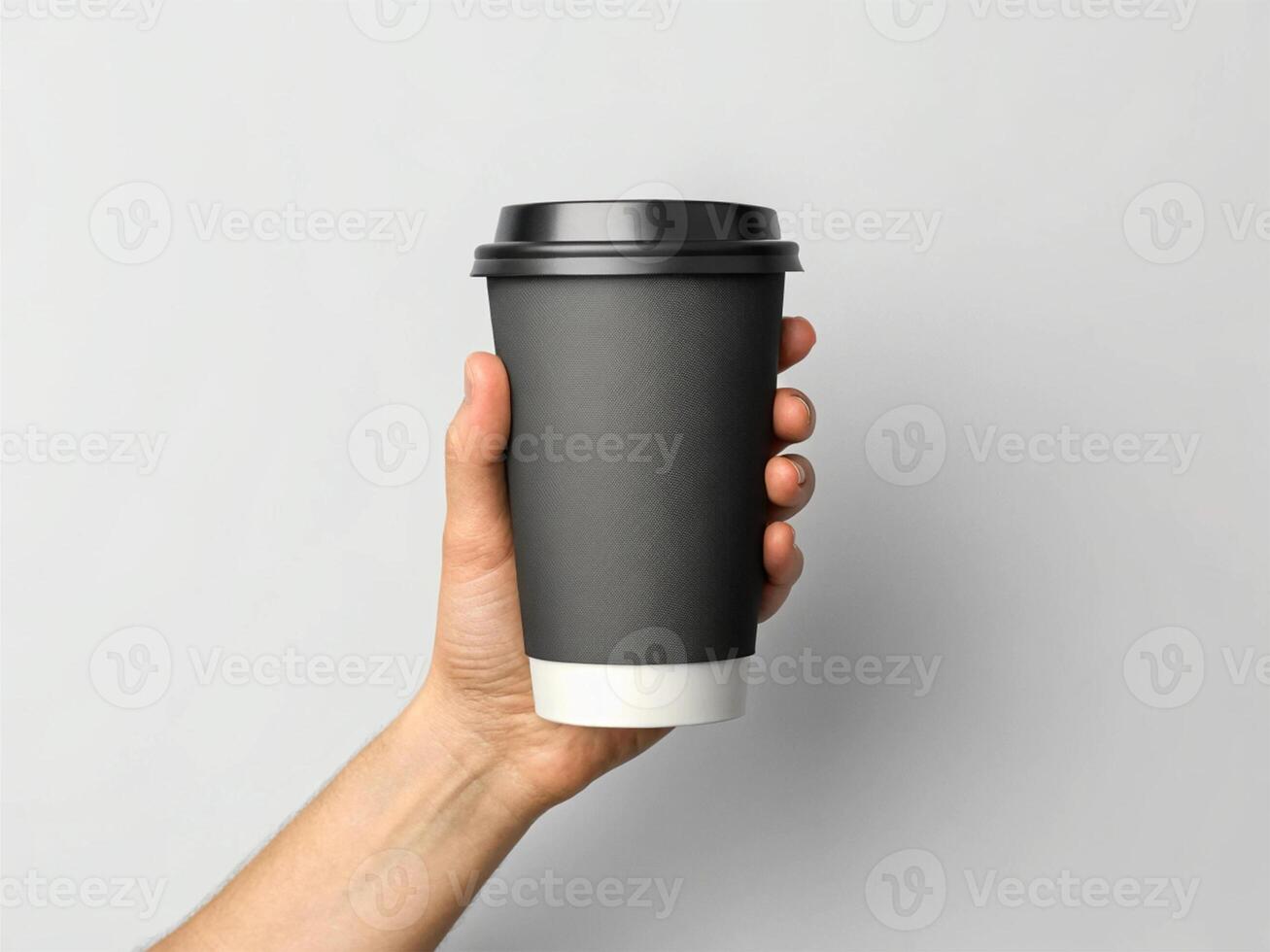 Hand holding a black disposable coffee cup with a black lid, featuring a white base, against a plain, light gray backgroun - Minimalist Beverage Concept photo