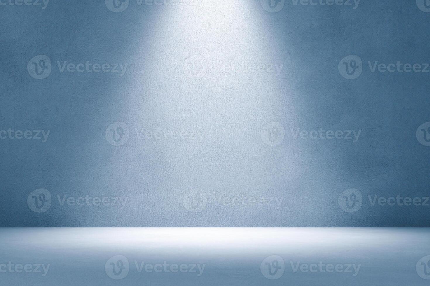 A smooth, solid blue-gray wall and floor are lit by a bright, white spotlight from above photo