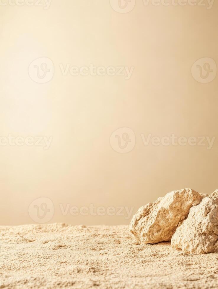 Textured beige surface with rock formations in the foreground against a uniform backdrop photo