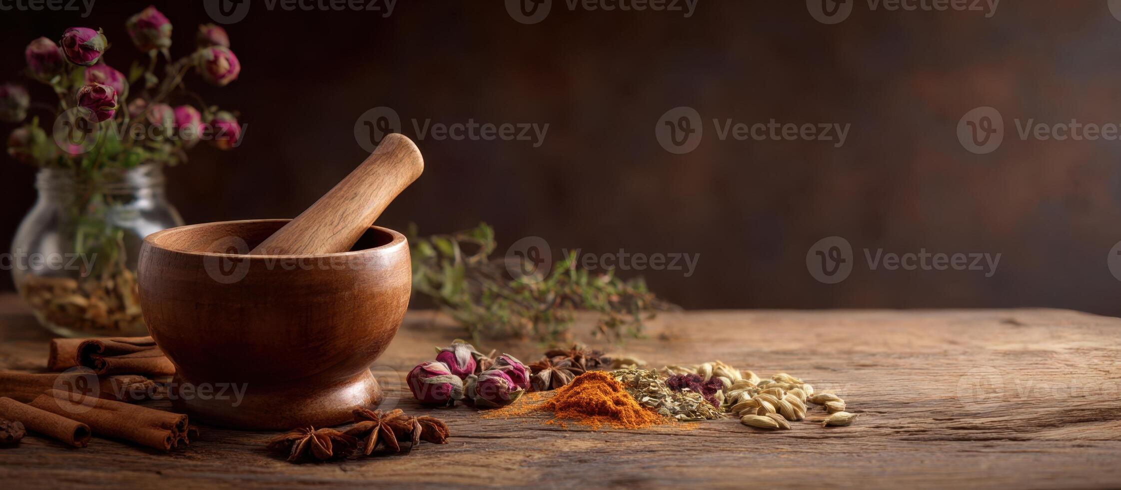 A rustic still life with a wooden mortar and pestle surrounded by an assortment of spices and botanicals on an aged wooden surface. photo