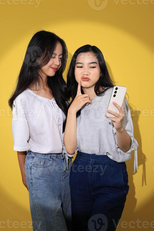 Two Generation Z Girl Taking Selfie Together using Smartphone photo