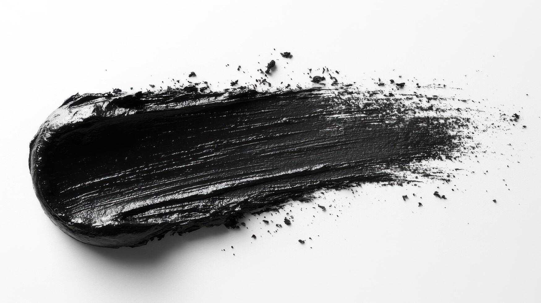 Black paint applied smoothly on a surface showcasing rich texture and depth during an artistic creation process photo