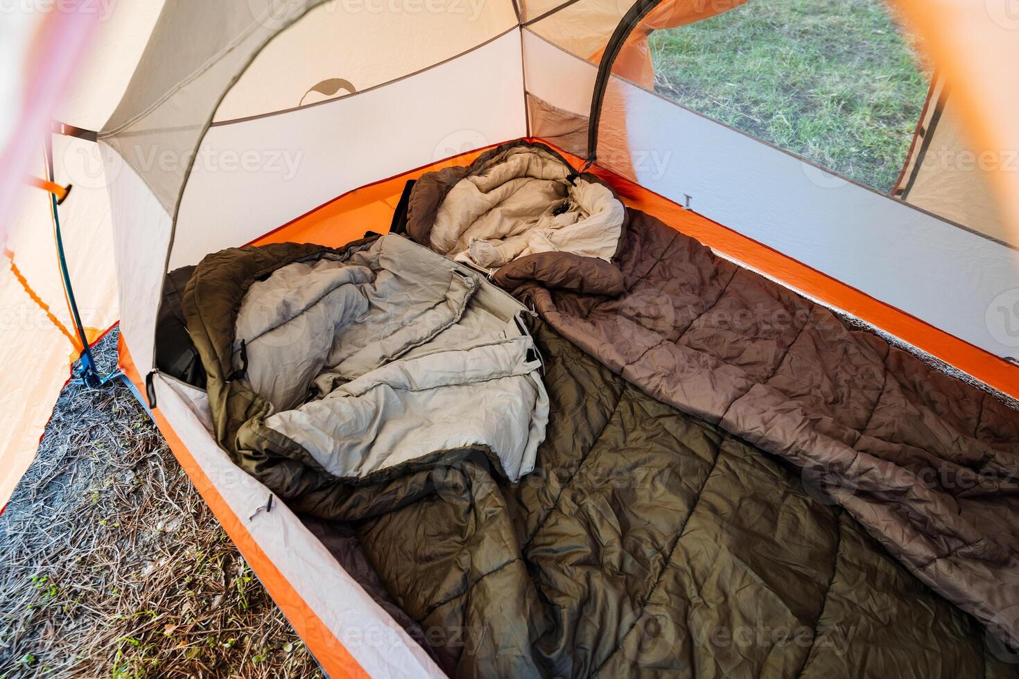 Experience the warmth and comfort of a cozy camping setup inside a vibrant colorful tent, complete with soft sleeping bags and warm blankets, perfect for relaxation and recreation in nature photo