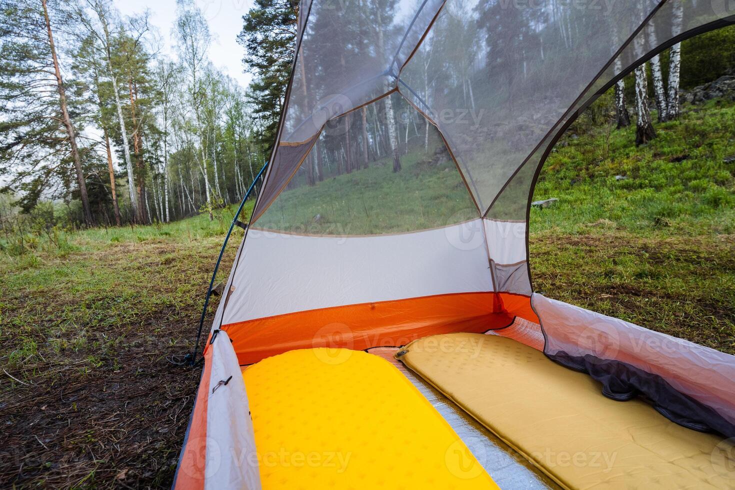 A Cozy Camping Tent Interior featuring Soft Sleeping Pads nestled within the Serene Embrace of Natures Beauty, perfect for enjoying peaceful nights under the stars amidst vibrant landscapes photo
