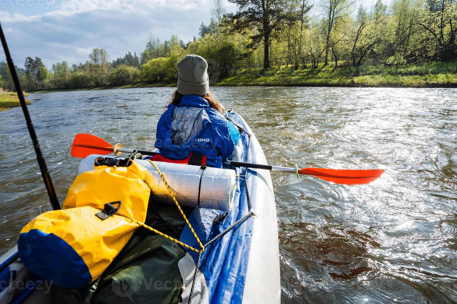 Experience the thrill of adventurous kayaking on a serene river that is beautifully surrounded by lush greenery and diverse wildlife, offering a perfect escape into natures tranquil embrace photo