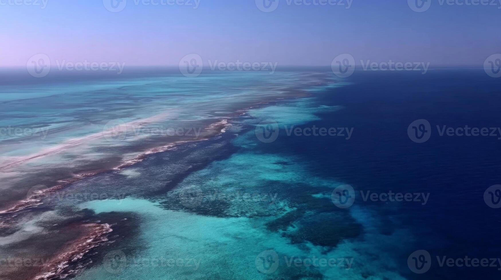 Aerial View of Vibrant Coral Reef with Clear Blue Water and Calm Ocean Horizon under a Bright Sky photo