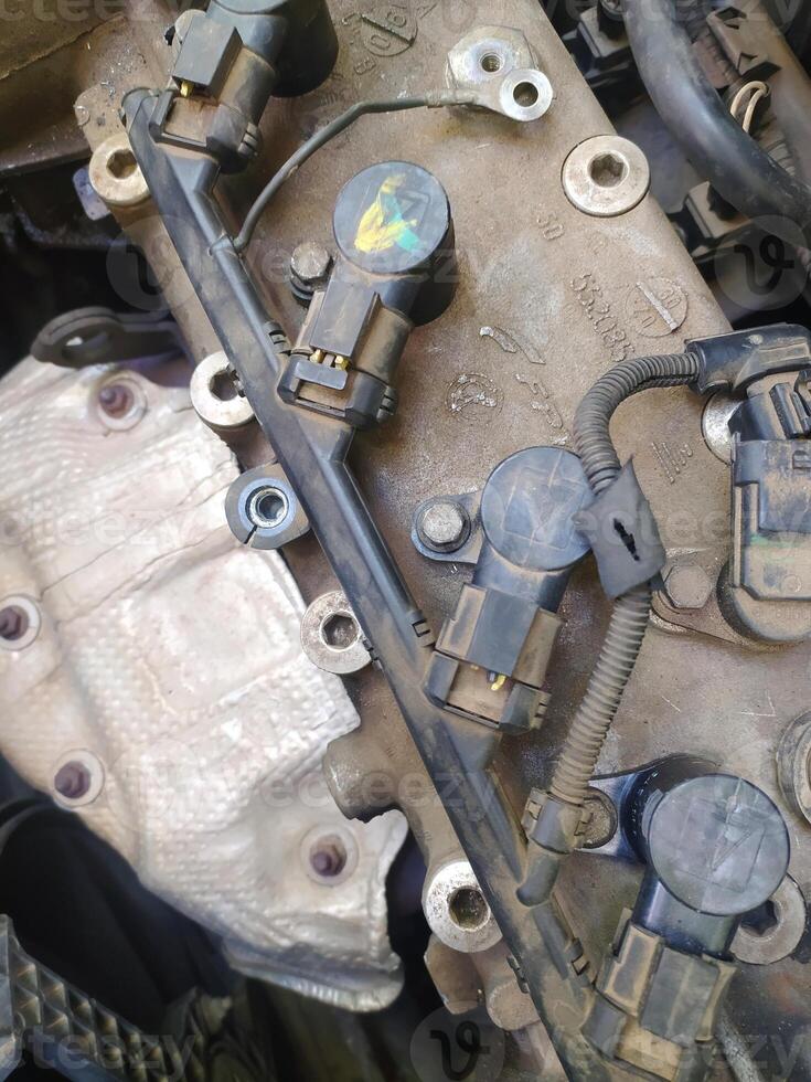 Ignition System of a Fiat 500 Sport 1.4 with Coils and Connectors - Engine Components Close-up of the Ignition Coils Attached to the Cylinder Head of a Fiat 1.4 16V Engine photo