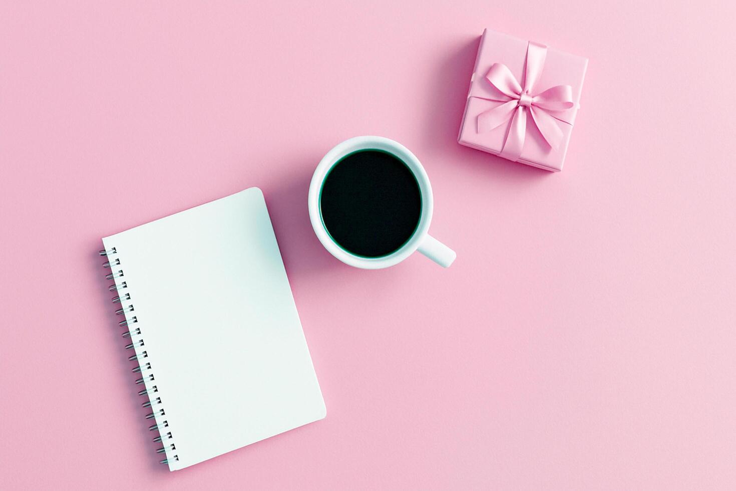 Minimal Pastel Flat Lay on Pink Background - Coffee, Notebook, and Gift Box for Feminine Lifestyle, Planning, and Morning Routines photo