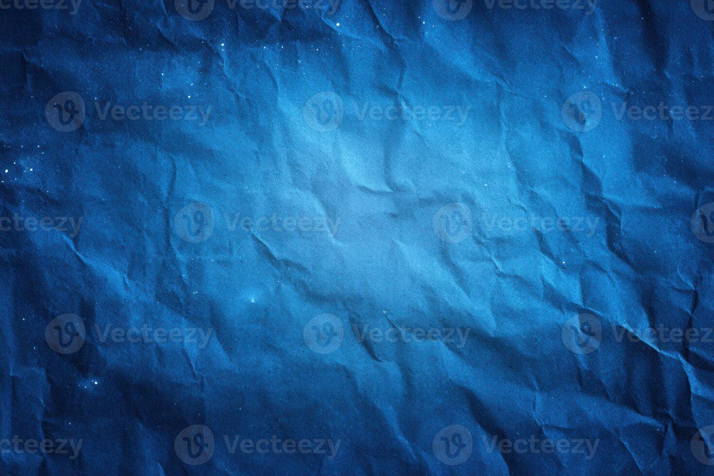 Deep blue crumpled paper texture, resembling a night sky with scattered stardust. Abstract backdrop photo