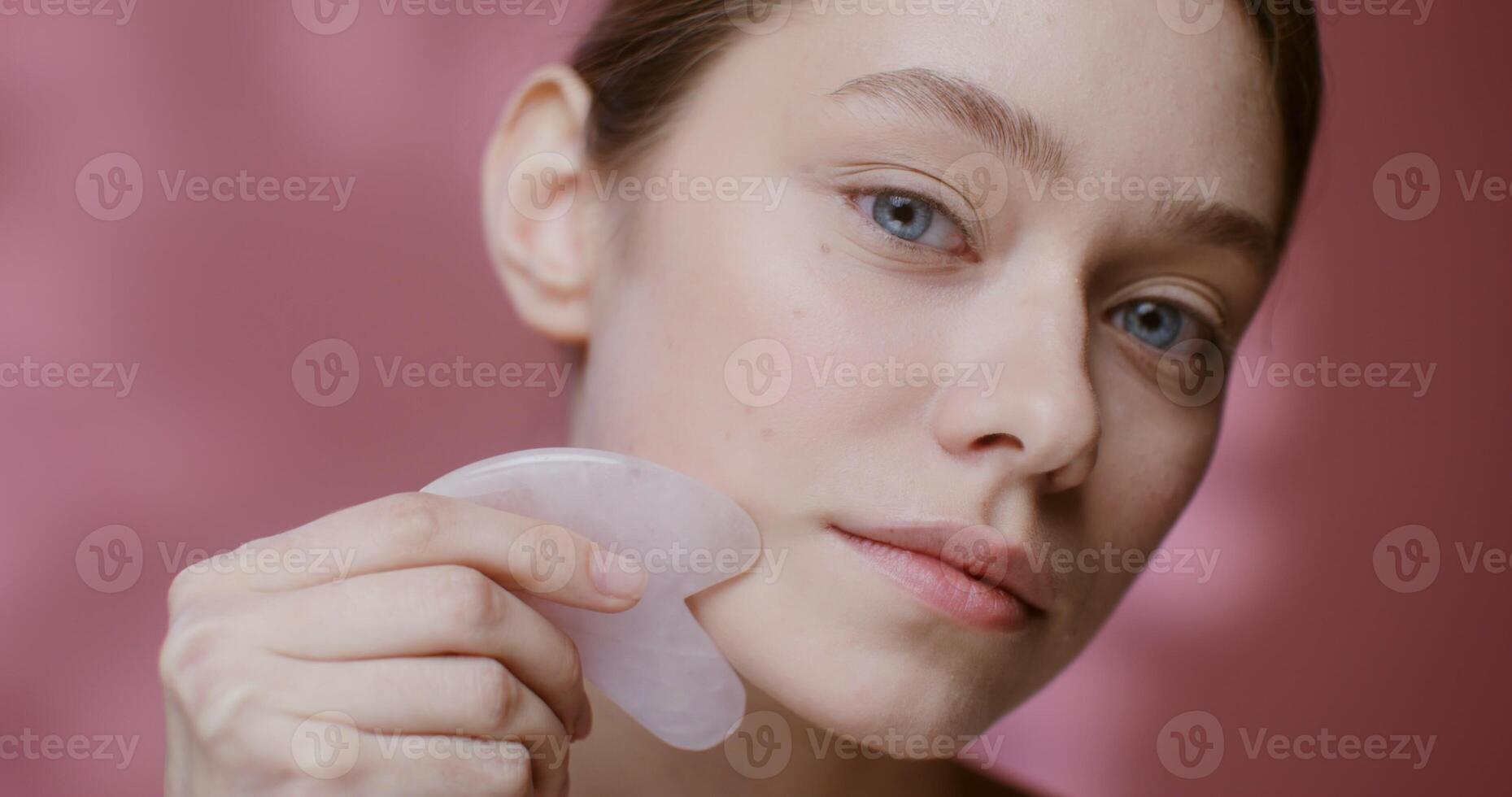 A woman holding a plastic piece of skin care photo