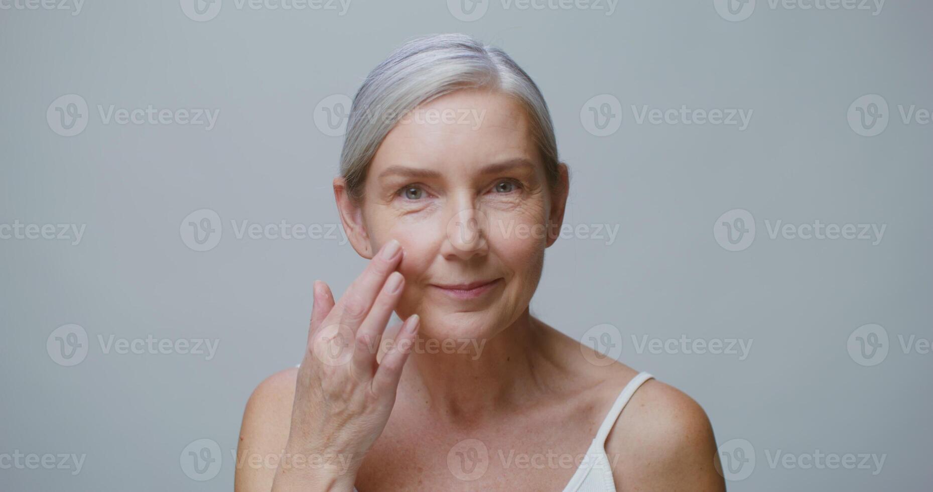 An older woman with her hand on her face photo