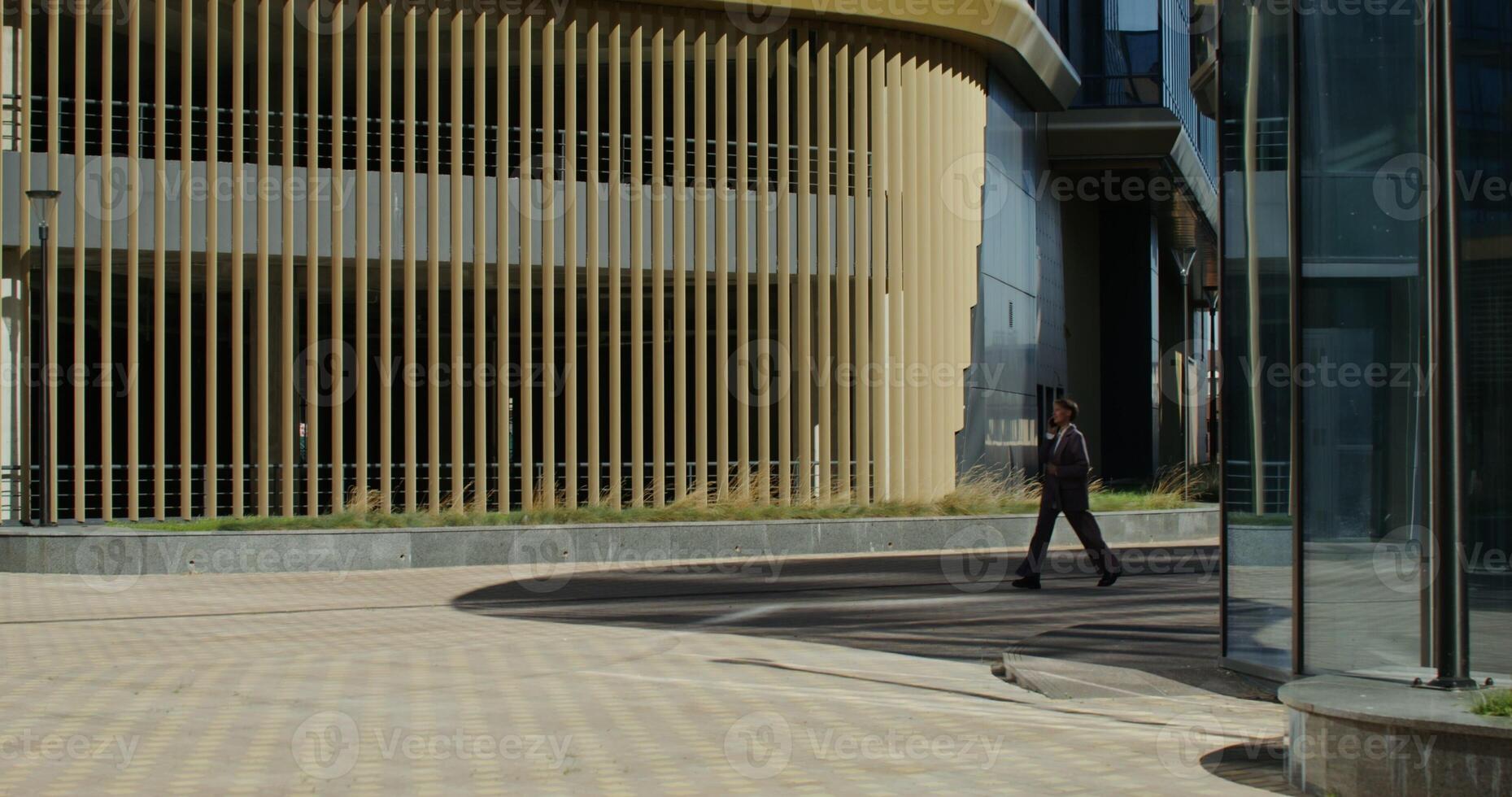 A man walking down a sidewalk photo