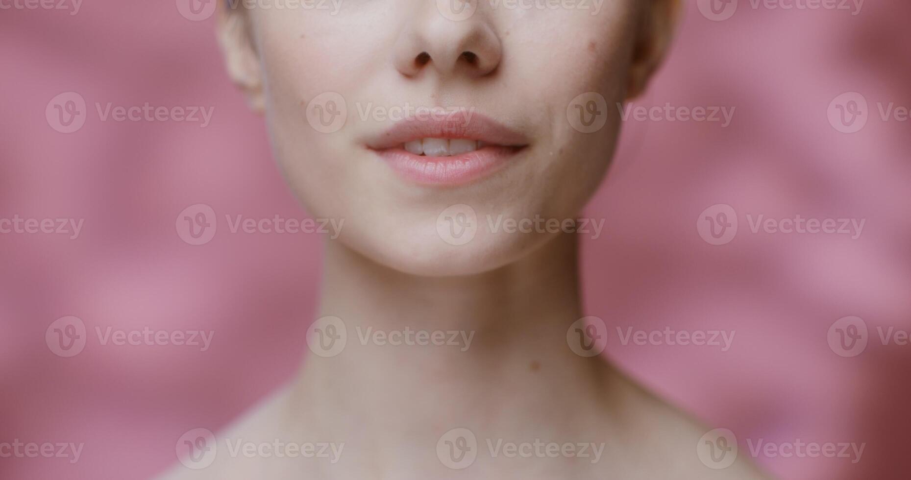 A woman with a pink background and a white shirt photo