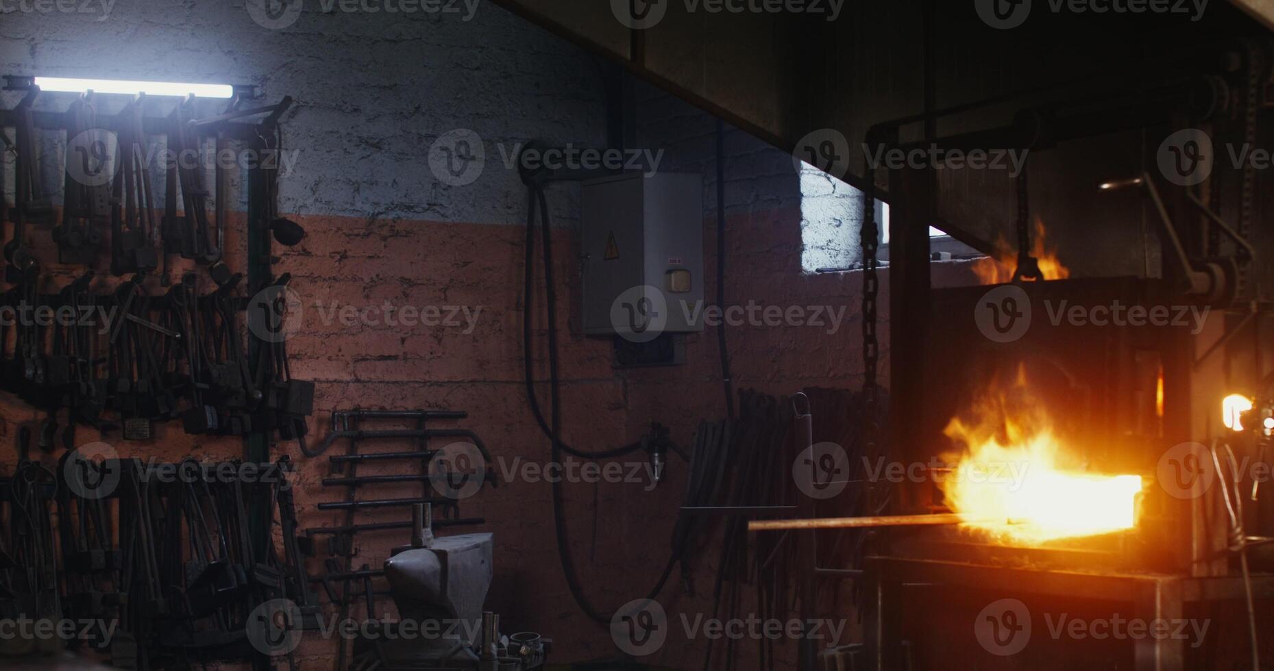 A man is working in a metal shop with a torch photo