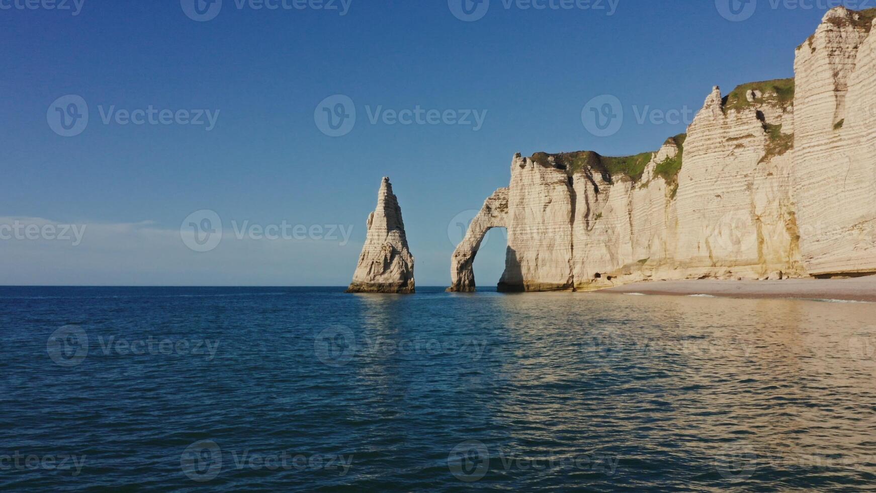 The beach is filled with white cliffs and water photo