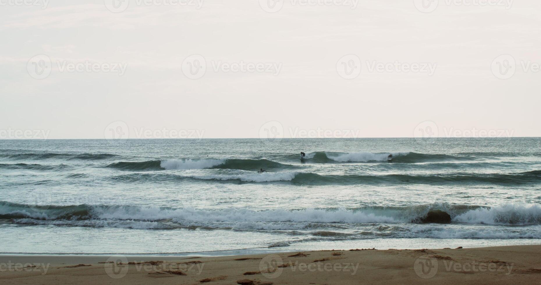 A man surfs on the waves photo