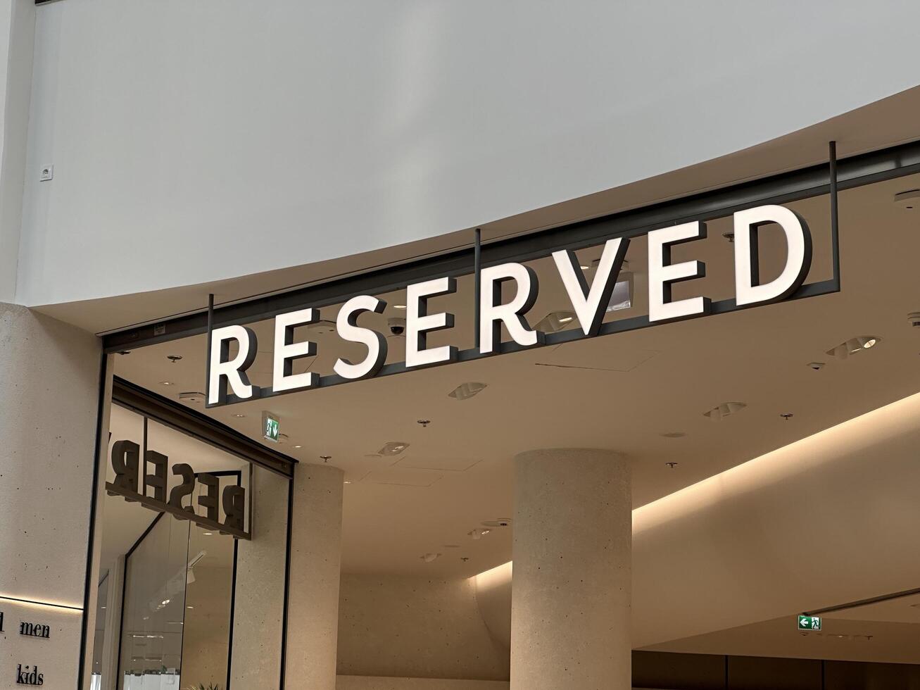 Warsaw, Poland - April 28, 2025 Reserved store sign, modern shopping mall, showcasing contemporary retail design and inviting shoppers to explore fashion and lifestyle offerings photo