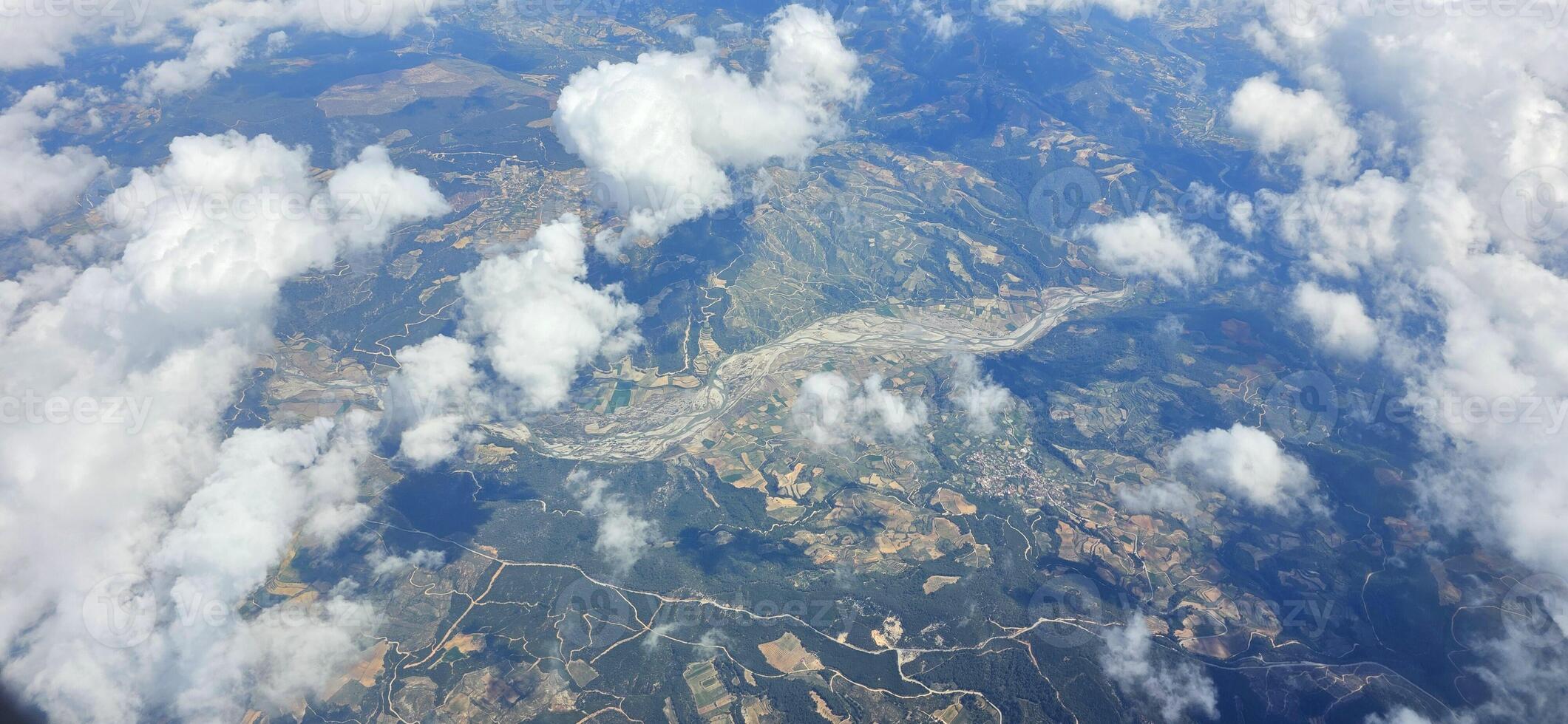Aerial view of landscape with clouds and mountains showcasing natural photo