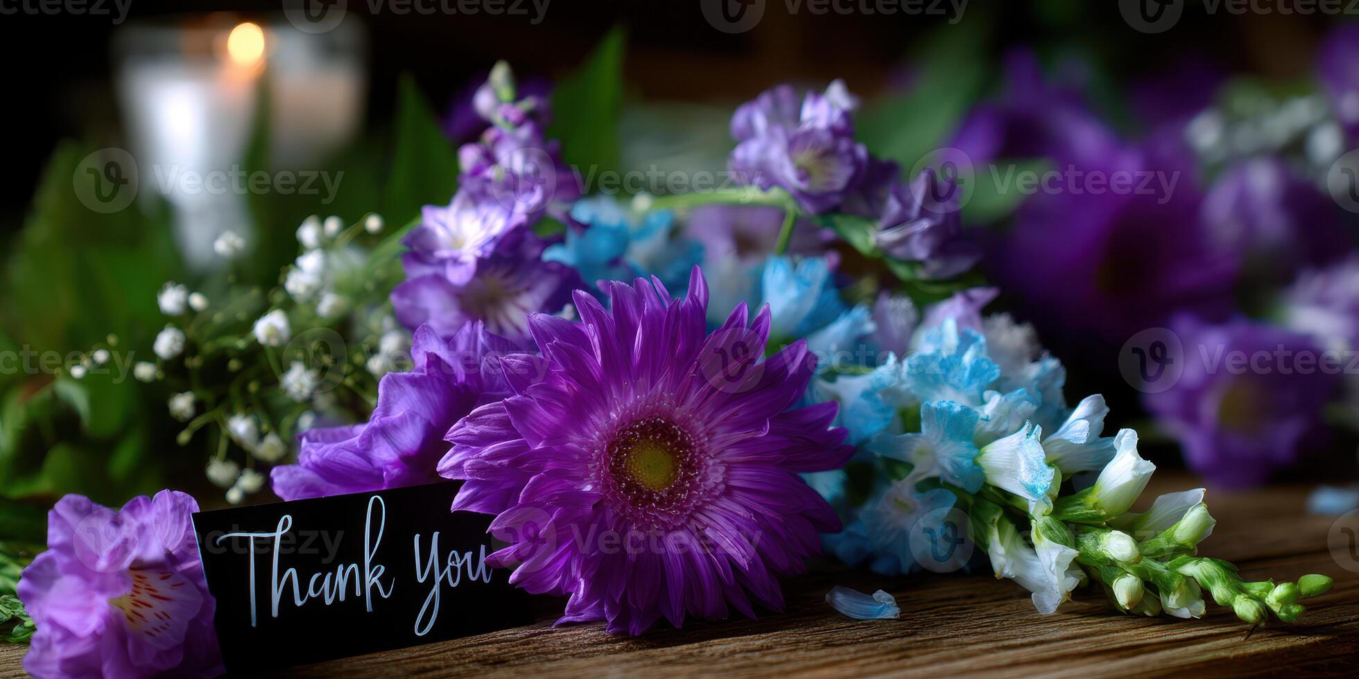 Vibrant arrangement of flowers with a thank you card on wooden table photo