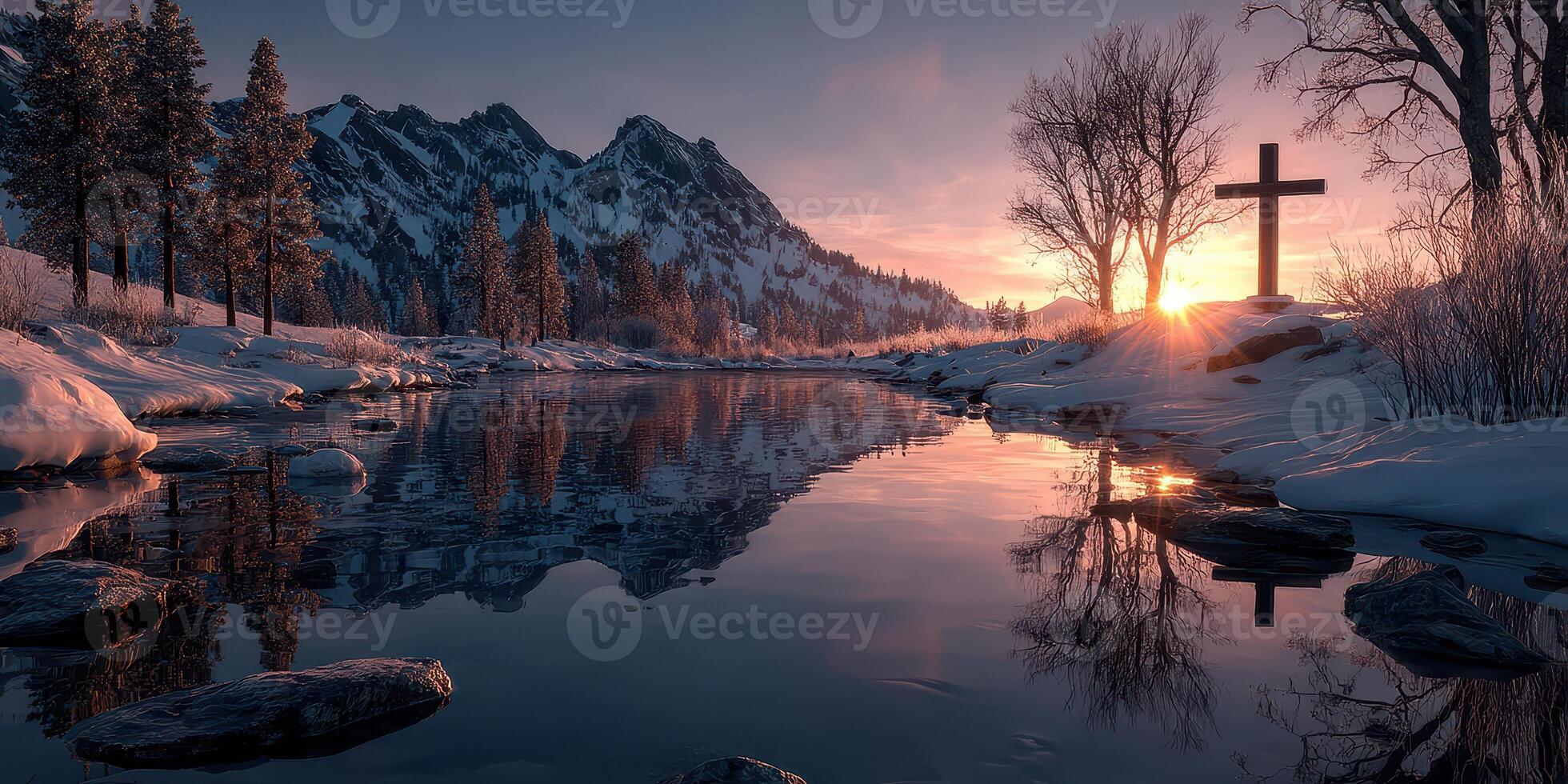 Winter sunset over a reflective river with snow-covered trees and a cross near the mountains photo