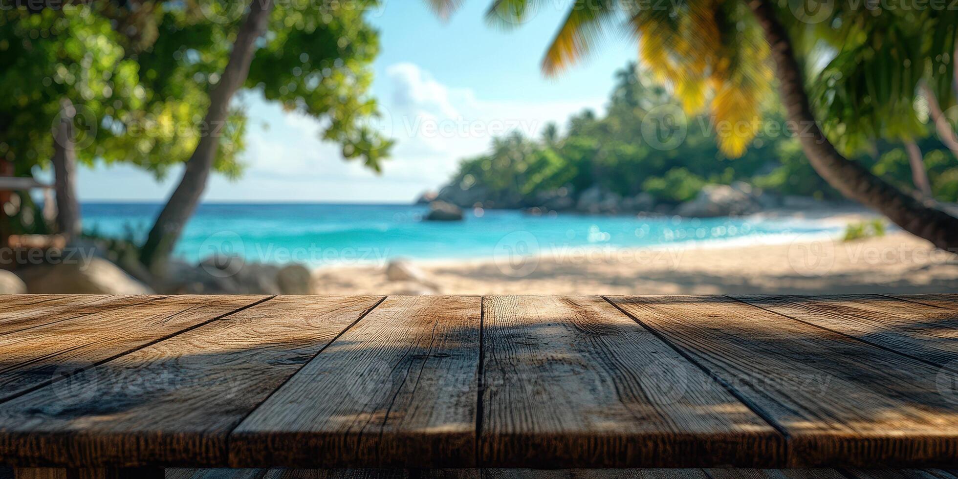 Scenic beach view with a wooden table foreground near clear ocean water on a sunny day photo