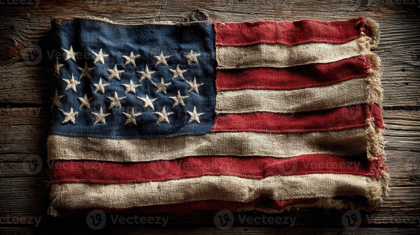 Worn American flag resting on rustic wooden surface highlighting its historical significance and craftsmanship photo