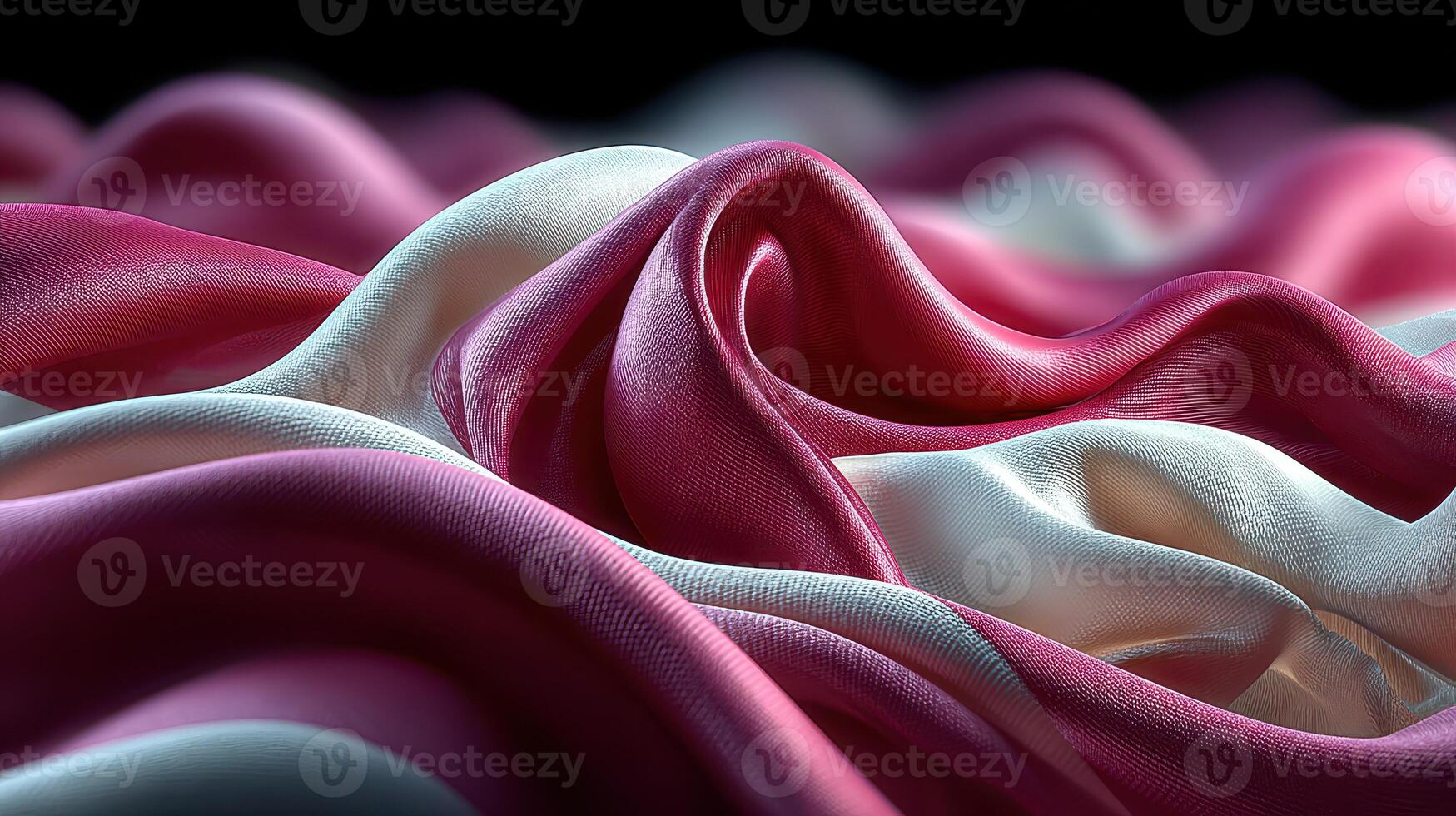 Colorful silk fabric draping elegantly in soft waves with a blend of pink and white hues photo