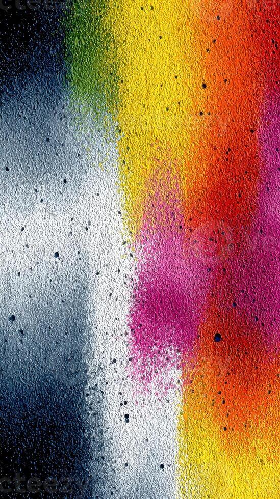 Colorful abstract texture created with spray paint on a rough surface in an urban setting during daytime photo
