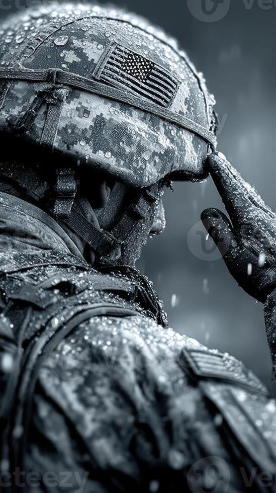 Soldier saluting under rain with determination and honor during military exercise in a remote training area photo