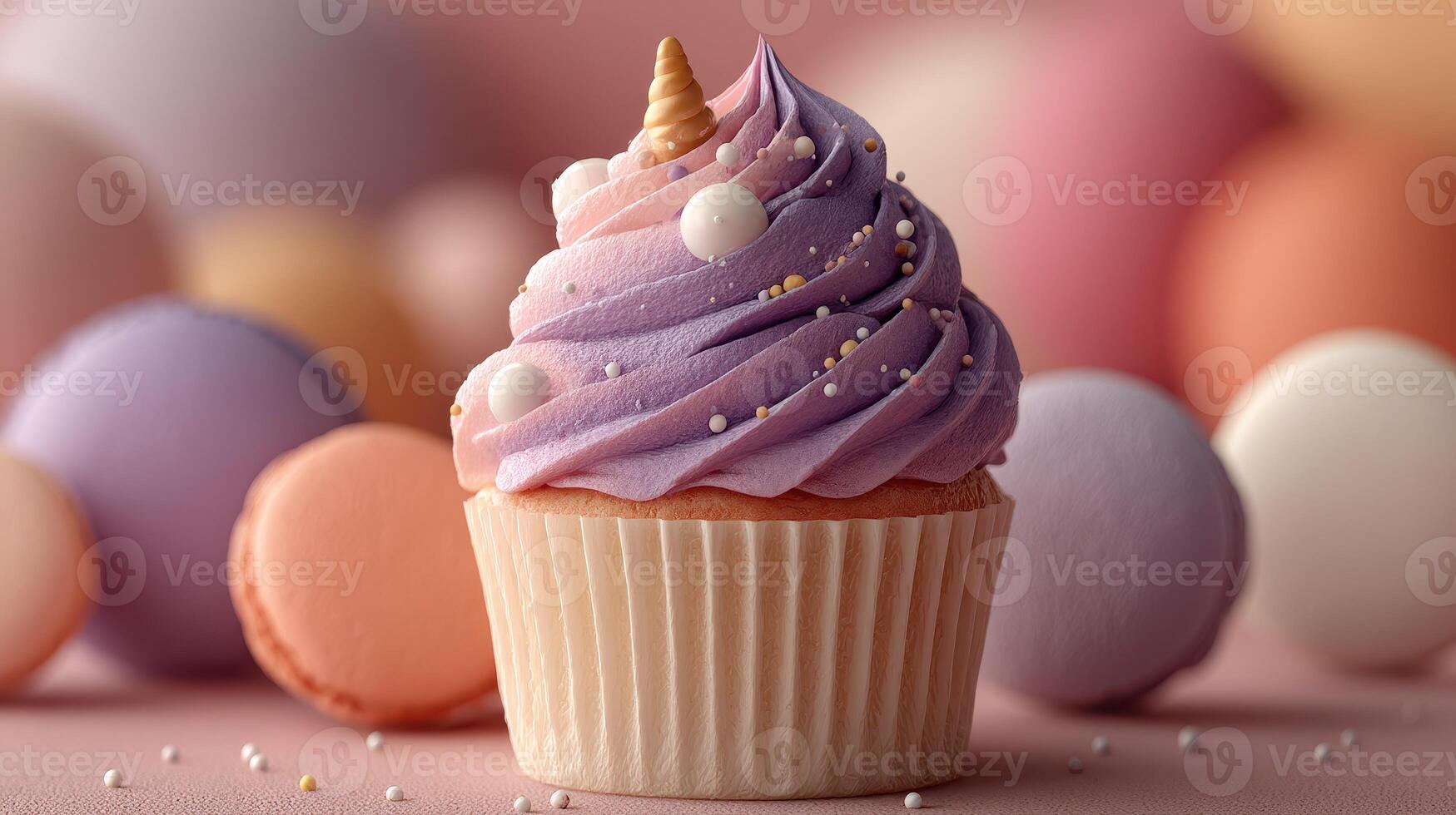 Colorful decorative cupcake topped with purple frosting and sprinkles surrounded by pastel macarons on a pink surface photo