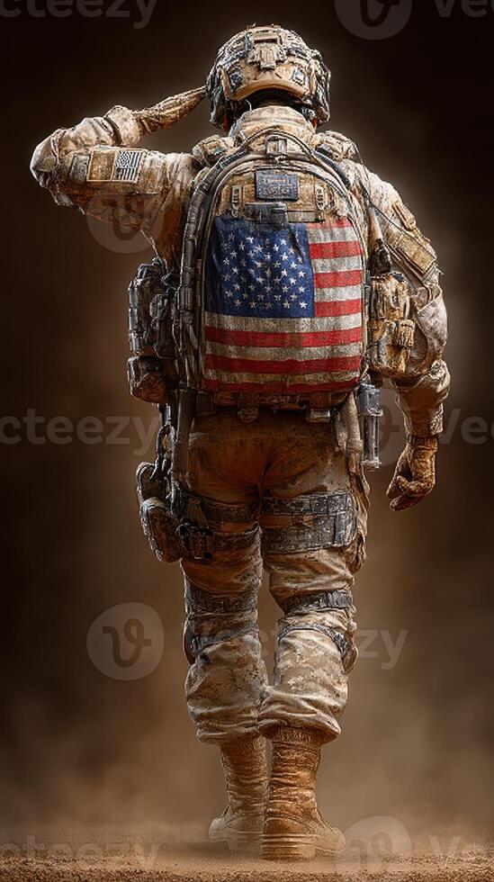 Soldier saluting with American flag patch on backpack in a dusty environment during military operation photo