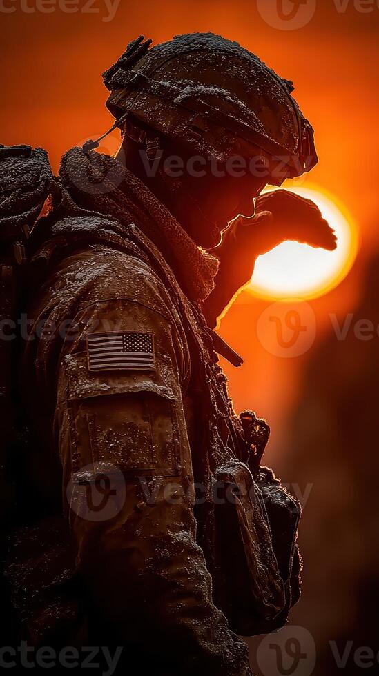 Soldier salutes at sunset in a cold, snowy landscape during a military operation photo