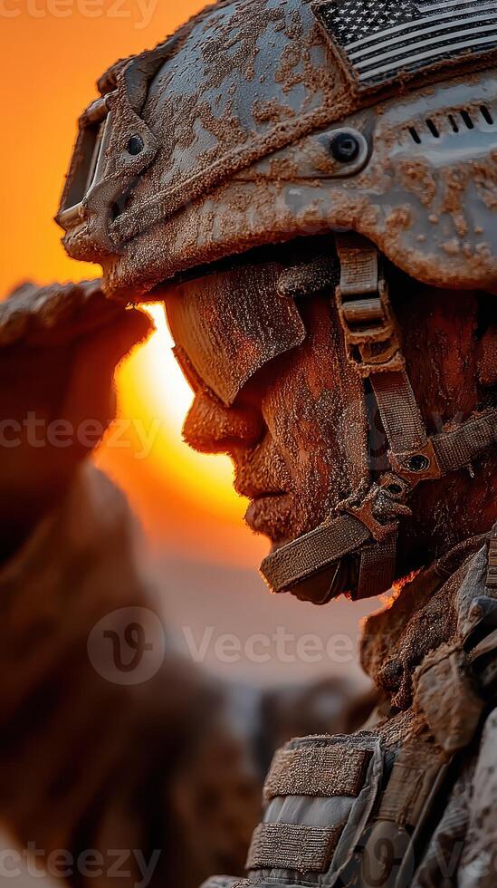 Soldier saluting at sunset with a dusty uniform and helmet during a mission in a desert environment photo