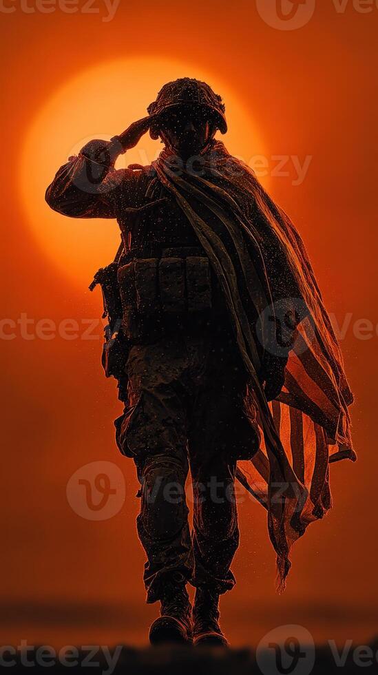 Soldier saluting while draped in flag against a vibrant sunset backdrop at a military memorial site photo
