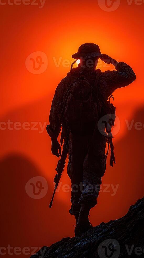 Soldier saluting against an orange sunset backdrop highlighting the dedication and bravery of military personnel photo
